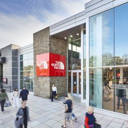Shoppers walk past The North Face and Kanki at Crabtree Valley Mall.