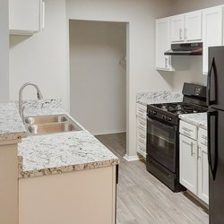 The Life at Elmwood Grove - Beautiful renovated kitchen featuring sleek granite countertops, energy efficient appliances, and white shaker cabinetry.