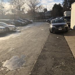 Tiny parking lot with nowhere to park except in front of the bays or middle of their drive area. Tiny parking lot with nowhere to park except in front of the bays or middle of their drive area.