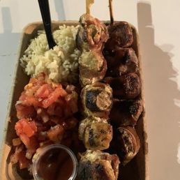 Bacon wrapped steak, bacon wrapped chicken, rice, and vinaigrette salad with some bbq sauce Bacon wrapped steak, bacon wrapped chicken, rice, and vinaigrette salad with some bbq sauce