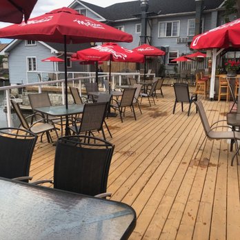 The Bobcaygeon Inn - a deck with tables and chairs and umbrellas - Pubs Near Me - Bobcaygeon, Ontario The Bobcaygeon Inn - a deck with tables and chairs and umbrellas - Pubs Near Me - Bobcaygeon, Ontario