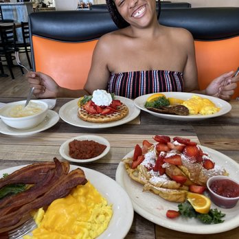 Eggscellent - Grits with cheese, Waffle with sausage and eggs. Salsa in the middle dish. Stuffed french toast with eggs and bacon and wildberry jam - Breakfast & Brunch Near Me - Las Vegas, Nevada