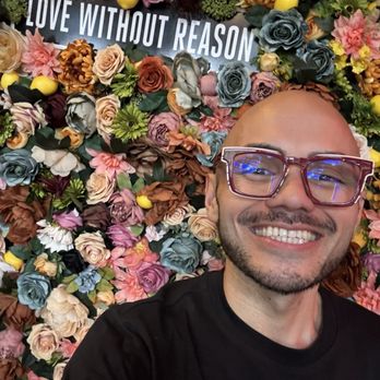 LaRayia’s Bodega - Selfie in front of "Love Without Reason" flower wall - Vegan Near Me - Atlanta, Georgia