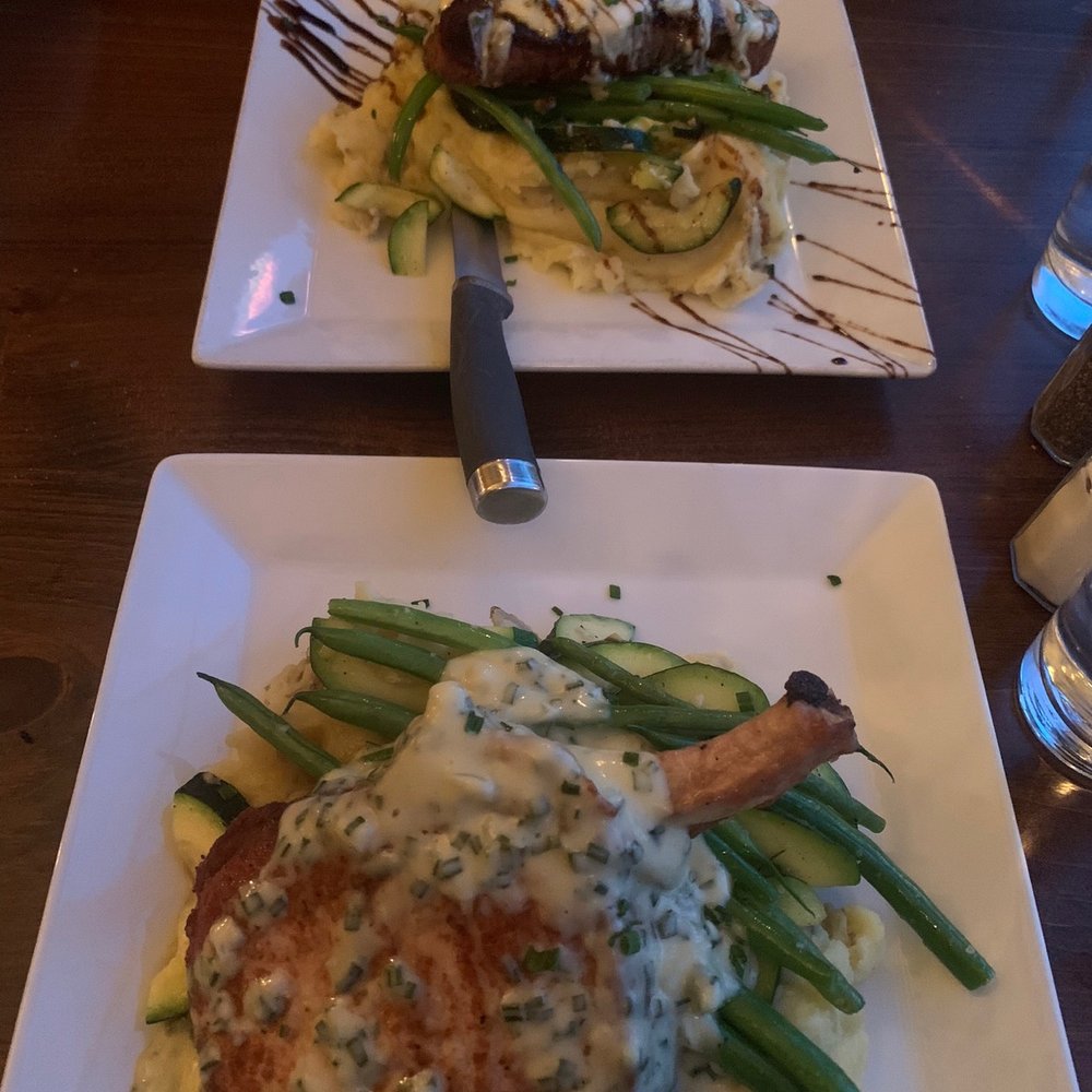 Gerties - Pork chop in front, strip steak behind. Both came with mashed potatoes and veggies - New American Near Me - Clarence Center, New York Gerties - Pork chop in front, strip steak behind. Both came with mashed potatoes and veggies - New American Near Me - Clarence Center, New York