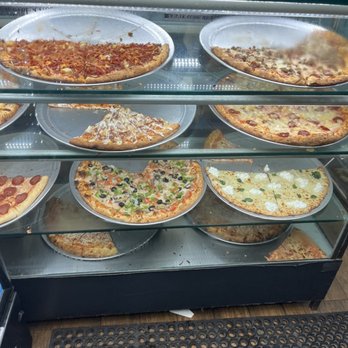 99 Cent Delicious Pizza - a display of pizzas - Pizza Near Me - New York, New York 99 Cent Delicious Pizza - a display of pizzas - Pizza Near Me - New York, New York