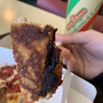 Rocky Rococo Pizza & Pasta - a hand holding a piece of pizza - Pizza Near Me - Oshkosh, Wisconsin Rocky Rococo Pizza & Pasta - a hand holding a piece of pizza - Pizza Near Me - Oshkosh, Wisconsin