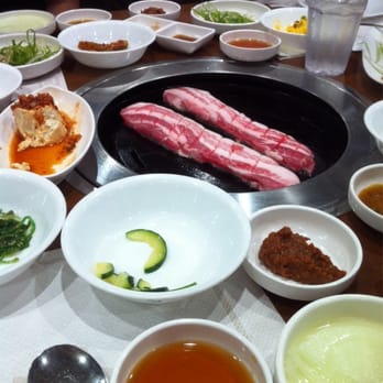 Hahm Ji Bach - Pork belly, kimchi side dishes, & some of the sauces they give you to go with the food. Best pork belly I've had! Delicious. - Korean Near Me - Flushing, New York