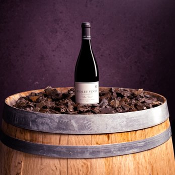 Violet Vines - a bottle of wine on a barrel - Wine Tasting Room Near Me - Carlton, Oregon Violet Vines - a bottle of wine on a barrel - Wine Tasting Room Near Me - Carlton, Oregon