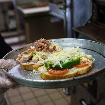 Sarpino's Pizzeria - a person holding a plate of food - Pizza Near Me - Shawnee, Kansas Sarpino's Pizzeria - a person holding a plate of food - Pizza Near Me - Shawnee, Kansas