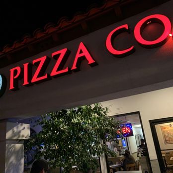 Temecula Pizza Company - a woman walking in front of a restaurant - Pizza Near Me - Temecula, California Temecula Pizza Company - a woman walking in front of a restaurant - Pizza Near Me - Temecula, California
