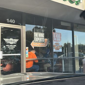 Wingstop - 2 topper table right between main door and soda machine. Guy near soda machine had to move plenty of times for guests to get their drinks. - Chicken Wings Near Me - Santa Clara, California