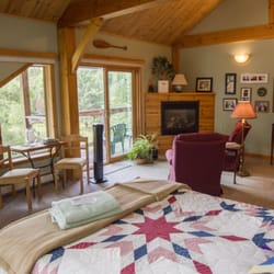 Sunny Rock Bed & Breakfast - High salted cathedral ceiling timber frame designed suites with sitting area and fireplace.