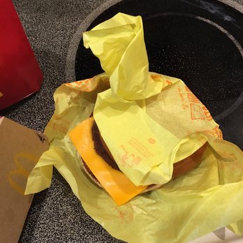McDonald's - An open and unwrapped cold cheeseburger. - Fast Food Near Me - Pembroke Pines, Florida McDonald's - An open and unwrapped cold cheeseburger. - Fast Food Near Me - Pembroke Pines, Florida