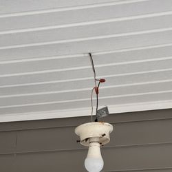 Liberty Home Inspectors - "Exposed exterior light wiring found during a Newark, NJ home inspection. Safety hazards like this are why inspections matter."