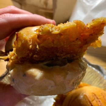 Holy Schnitzel - a hand holding a fried schnitzel - Kosher Near Me - New York, New York Holy Schnitzel - a hand holding a fried schnitzel - Kosher Near Me - New York, New York