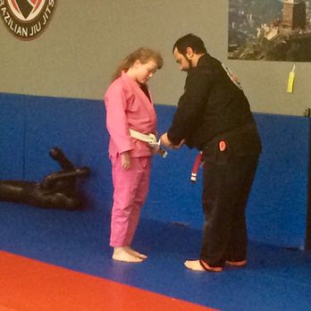 Gracie United Slidell - Professor Trey awarding a white belt student her first stripe - Boxing Near Me - Slidell, Louisiana Gracie United Slidell - Professor Trey awarding a white belt student her first stripe - Boxing Near Me - Slidell, Louisiana