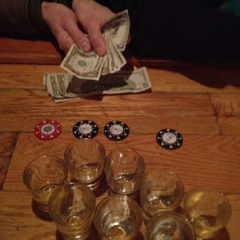 Snug Harbor - a person holding a stack of money and several shot glasses of whiskey - Dive Bars Near Me - New Paltz, New York