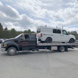 Adams Towing - Adams Towing hauling a work van to Swanzey, NH dealership