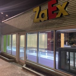 ZaEx - Store front with view of our custom display cases at night
