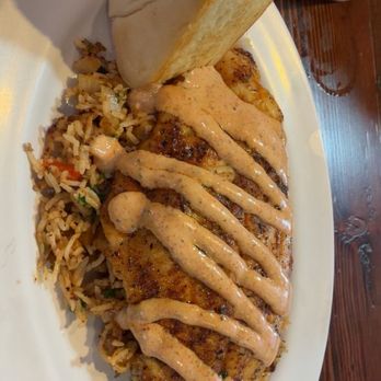Acadian Grille Scratch Kitchen - Blackened catfish with drizzled house made hollandaise sauce over dirty rice - Cajun/Creole Near Me - Omaha, Nebraska Acadian Grille Scratch Kitchen - Blackened catfish with drizzled house made hollandaise sauce over dirty rice - Cajun/Creole Near Me - Omaha, Nebraska