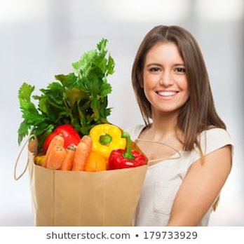 Bottomless Delivery - a woman holding a grocery bag full of vegetables - Food Delivery Services Near Me Bottomless Delivery - a woman holding a grocery bag full of vegetables - Food Delivery Services Near Me