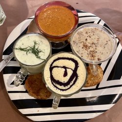 Thyme of Grace - Soup sampler clockwise, roasted red pepper bisque, cream of mushroom soup, chilled mango with blueberry swirl and chilled cucumber dill.