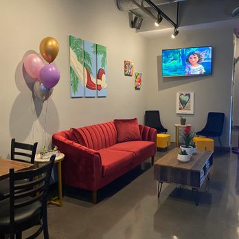 Undici Gelato - a living room with a red couch and balloons - Gelato Near Me - Itasca, Illinois