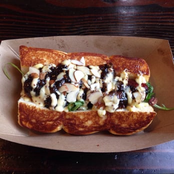 Dog Haus - Pasadena - The Pig & the Fig: Emmentaler cheese-stuffed sausage, fig-bacon-onion relish, wild arugula, whole grain mustard aioli and sliced almonds. - New American Near Me - Pasadena, California