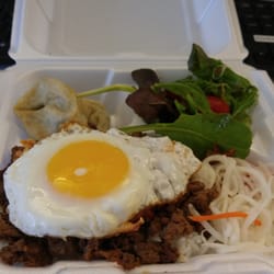 Galbi Q - Bulgogi over rice with two dumplings. With sides of Kim chi,  salad and pickled radishes!