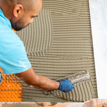 Broadway Tile Company - a man laying tile on the floor - General Contractors Near Me - Long Beach, New York Broadway Tile Company - a man laying tile on the floor - General Contractors Near Me - Long Beach, New York