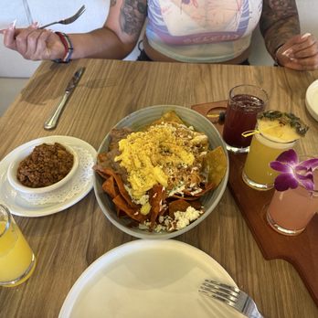 Chilaquiles Modern Kitchen - We got the chilaquiles divorciados with a side of chorizo and of course the flight of mimosas. - Breakfast & Brunch Near Me - Maricopa, Arizona