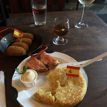 Austhentico - Tortilla española, pan con tomate, and jamón croquetas. Glass of sherry and some white wine to boot. - Spanish Near Me - Austin, Texas