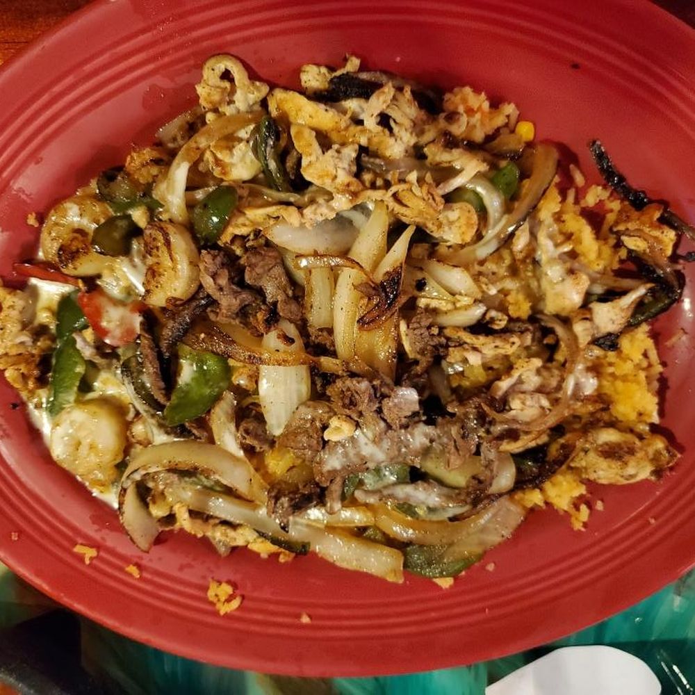 Jalisco (ha lees ko) steak, chicken, and shrimp grilled with fajita veggies, covered with white queso and served on Mexican rice Jalisco (ha lees ko) steak, chicken, and shrimp grilled with fajita veggies, covered with white queso and served on Mexican rice