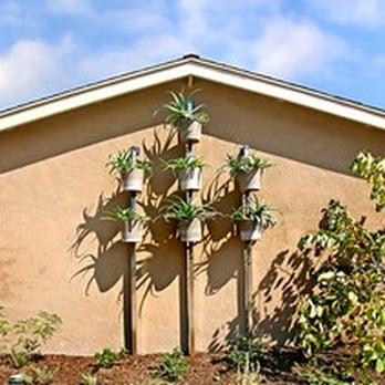 Tellus Design + Build - a house with a garden in front of it - General Contractors Near Me - Costa Mesa, California
