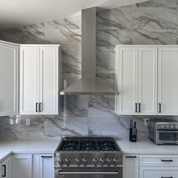New Empire Design Center - a kitchen with white cabinets and stainless steel appliances - Flooring Near Me - Lake Elsinore, California