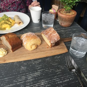 Tiny Boxwoods - Pastry Board (Lemon Poppy Bread, Banana Bread, Almond Croissant) and the Southside Breakfast plate. And White Wine Mojito (right corner) - New American Near Me - Houston, Texas Tiny Boxwoods - Pastry Board (Lemon Poppy Bread, Banana Bread, Almond Croissant) and the Southside Breakfast plate. And White Wine Mojito (right corner) - New American Near Me - Houston, Texas