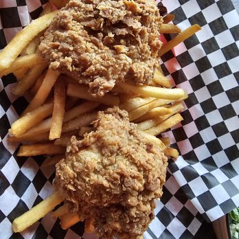 Triangle Spirits - Happy hour fried chicken thighs with fries.  It comes with 3 pieces,  but we had eaten one already. - Southern Near Me - Seattle, Washington