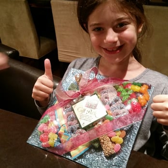 Oh Nuts - a young girl holding a bag of candy - Candy Stores Near Me - Cedarhurst, New York