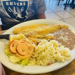 Filete al Mojo de Ajo - Fish in a garlic sauce. Rice, beans, and salad as sides. This plate also comes with homemade corn tortillas.