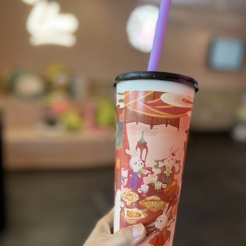 Ume Tea - a hand holding a paper cup with a purple straw - Bubble Tea Near Me - Davis, California Ume Tea - a hand holding a paper cup with a purple straw - Bubble Tea Near Me - Davis, California