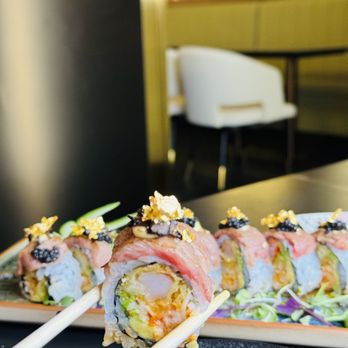 Kanji Sushi & Ramen - a close up of a roll with chopsticks - Sushi Bars Near Me - Brandon, Florida Kanji Sushi & Ramen - a close up of a roll with chopsticks - Sushi Bars Near Me - Brandon, Florida