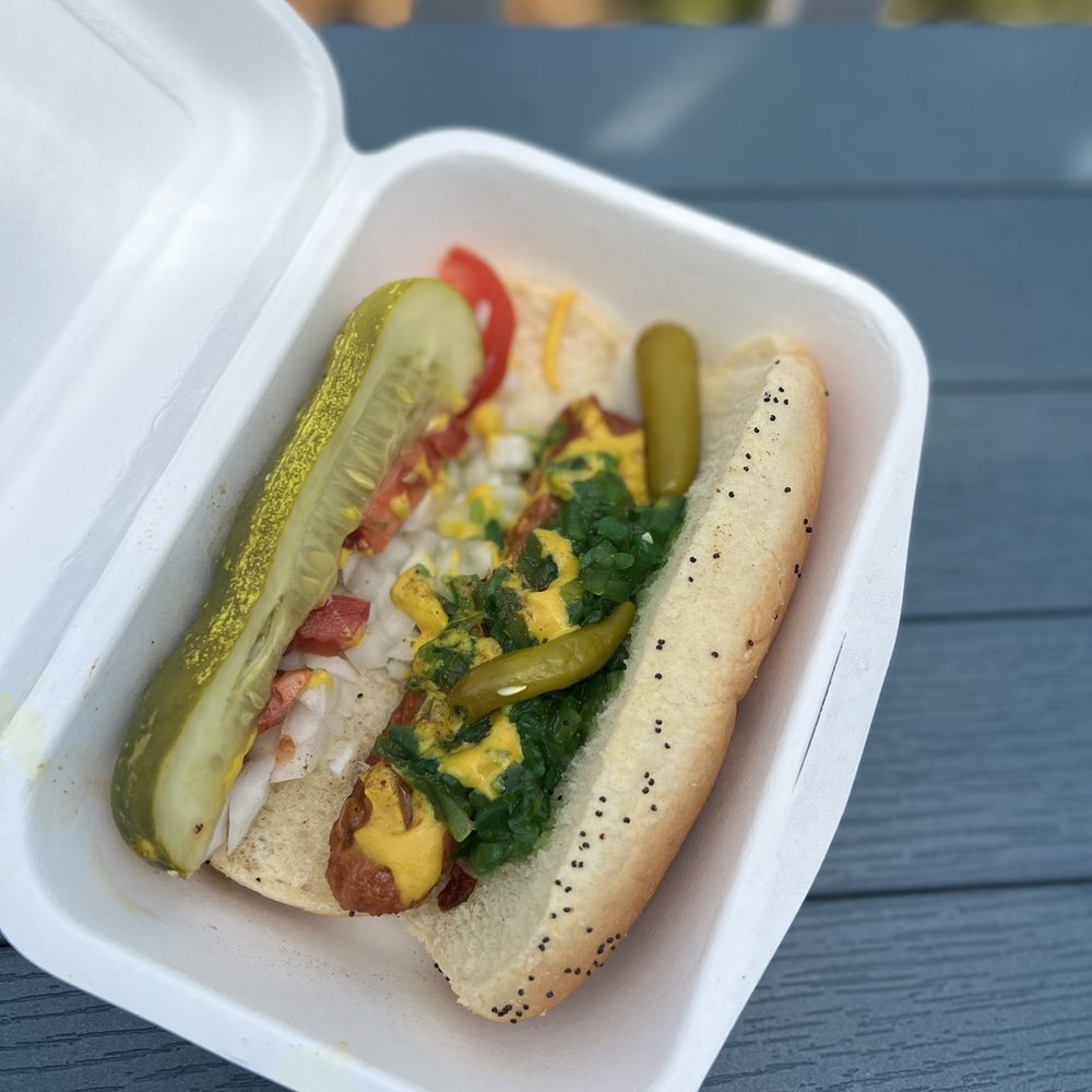 DogSlinger - Chicago Dog (veg): yellow mustard, neon green relish, onion, tomato slices, a kosher spear, sport peppers, celery salt - Hot Dogs Near Me - Stevensville, Michigan DogSlinger - Chicago Dog (veg): yellow mustard, neon green relish, onion, tomato slices, a kosher spear, sport peppers, celery salt - Hot Dogs Near Me - Stevensville, Michigan