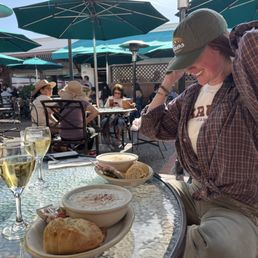 2 Traveler's specials in the sunshine at their patio tables. 2 Traveler's specials in the sunshine at their patio tables.