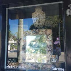 Newlin's - Newlin's is chock-full of fantastic gourmet food, along with art, unique tablescaping pieces and gifts! Here a seashell mirror in the window