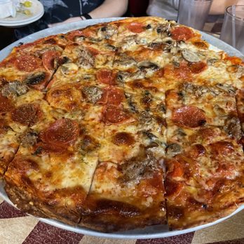 Lucca Grill - Chicago style, thin crust, pizza. The kind you find and taverns all over the city. Cracker crust and cut into squares. Delicious! - Pizza Near Me - Bloomington, Illinois