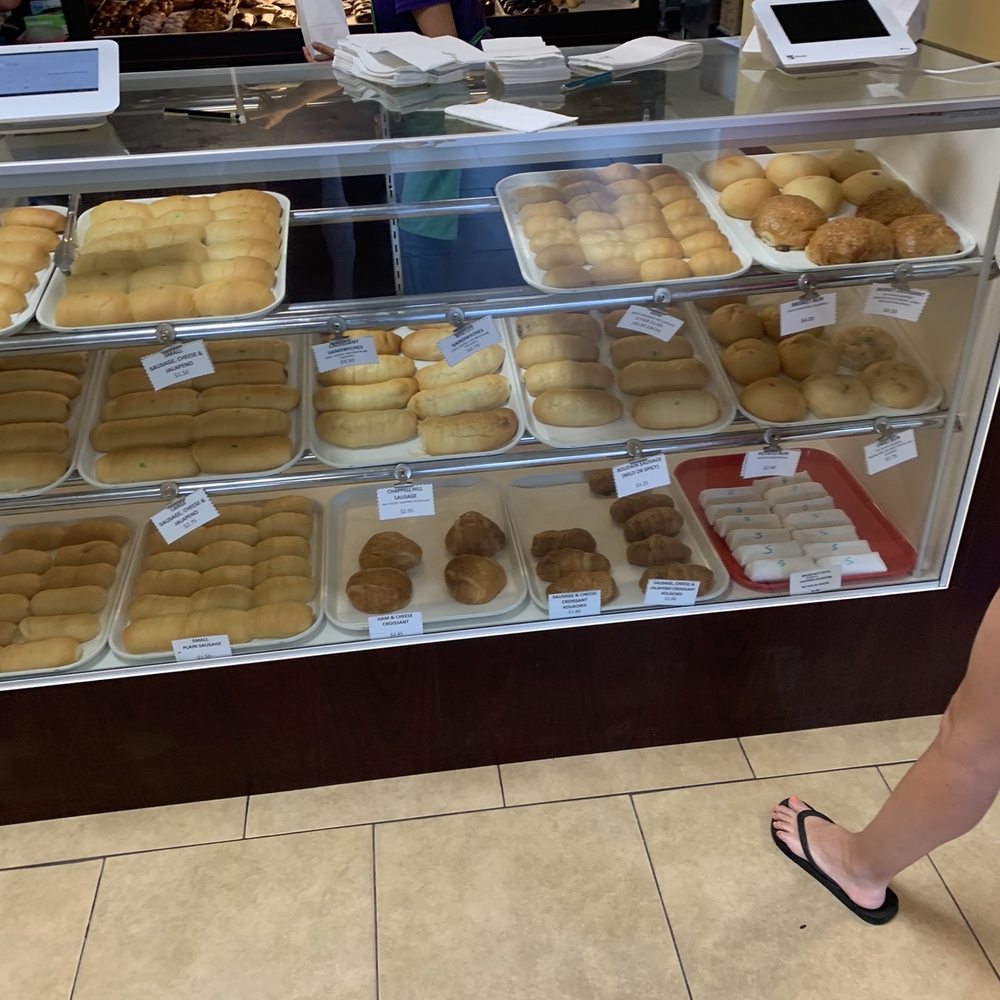 OMG! Donuts & More - a woman standing in front of a bakery - Donuts Near Me - Cypress, Texas