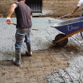 ZK Contracting - a man pushing a wheelbarrow - General Contractors Near Me - The Bronx, New York ZK Contracting - a man pushing a wheelbarrow - General Contractors Near Me - The Bronx, New York