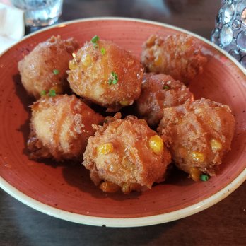 Grace & Grit - Hushpuppies with honey drizzle. - Southern Near Me - Mount Pleasant, South Carolina Grace & Grit - Hushpuppies with honey drizzle. - Southern Near Me - Mount Pleasant, South Carolina