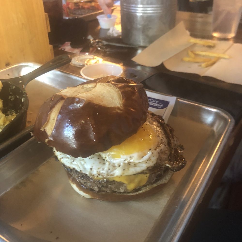 Sids Garage - Don't know the name but it's got an egg on the burger and on a pretzel bun - Burgers Near Me - Meridian, Idaho Sids Garage - Don't know the name but it's got an egg on the burger and on a pretzel bun - Burgers Near Me - Meridian, Idaho