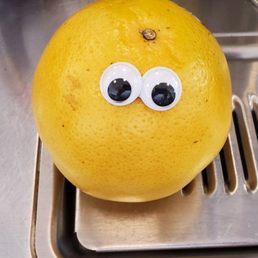 A grapefruit with googly eyes, the staff here have fun personalities!